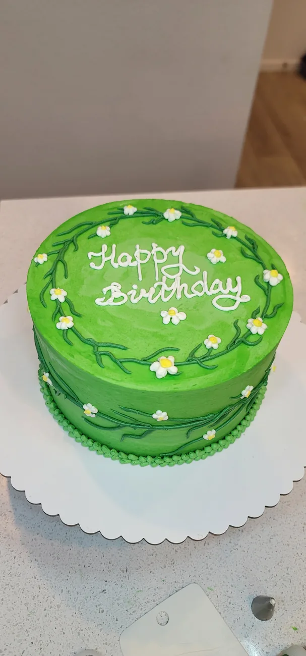 Green birthday cake with floral decoration